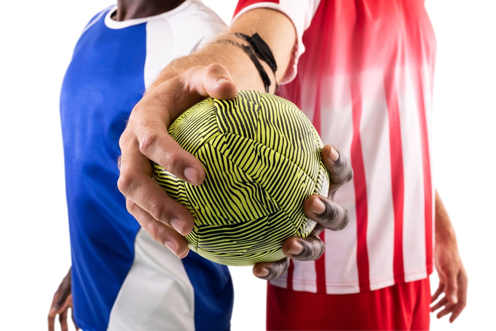 A handball held up between two players
