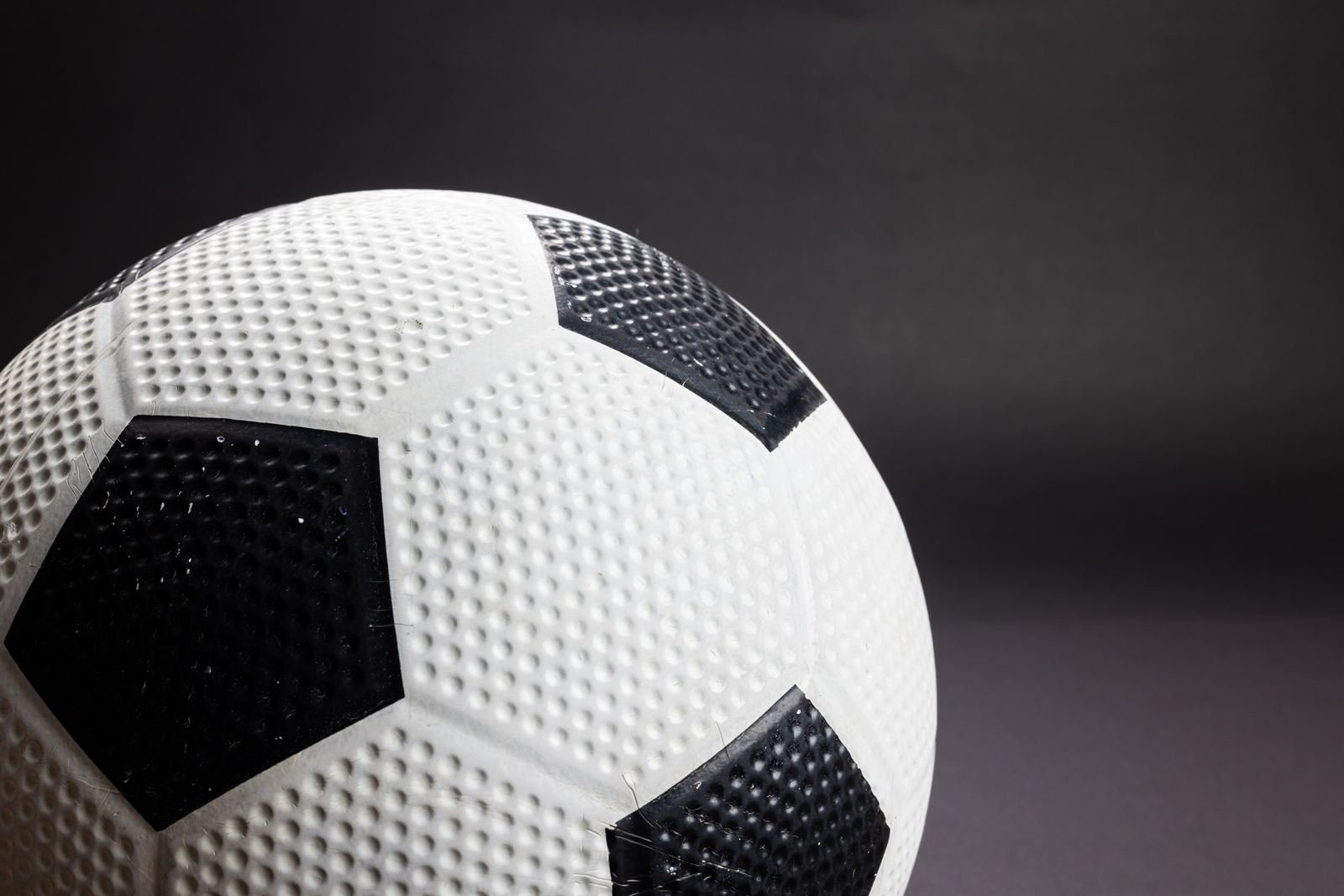 A black and white football, close up