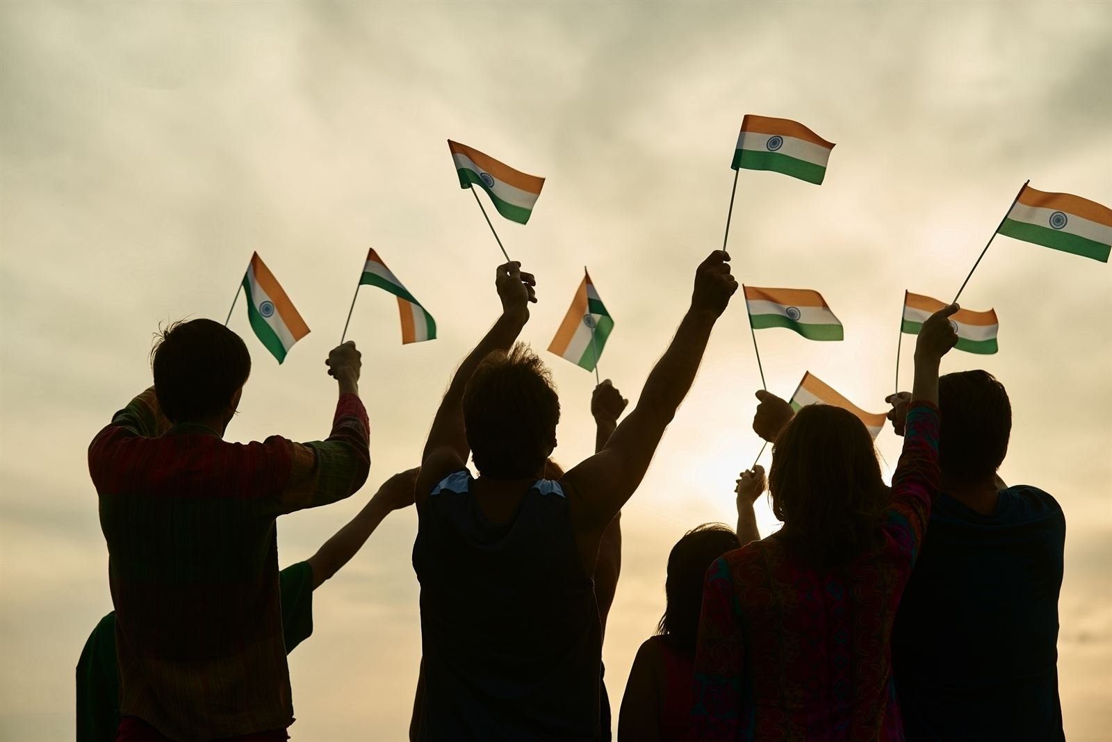 Fans waving Indian flags against the evening sky