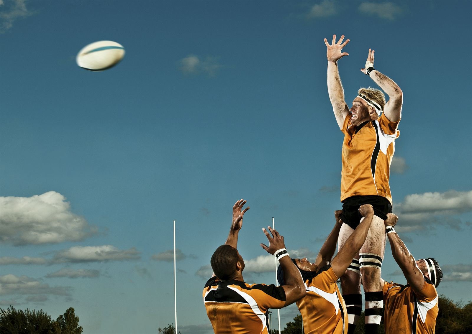 A rugby line-out, with a player lifted to catch the ball